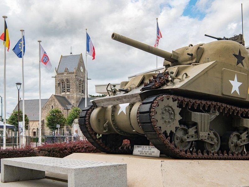 A Sherman tank and the church tower at Sainte-Mere-Eglise