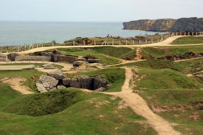 The cratered ground at Pointe du Hoc with the cliffs beyond
