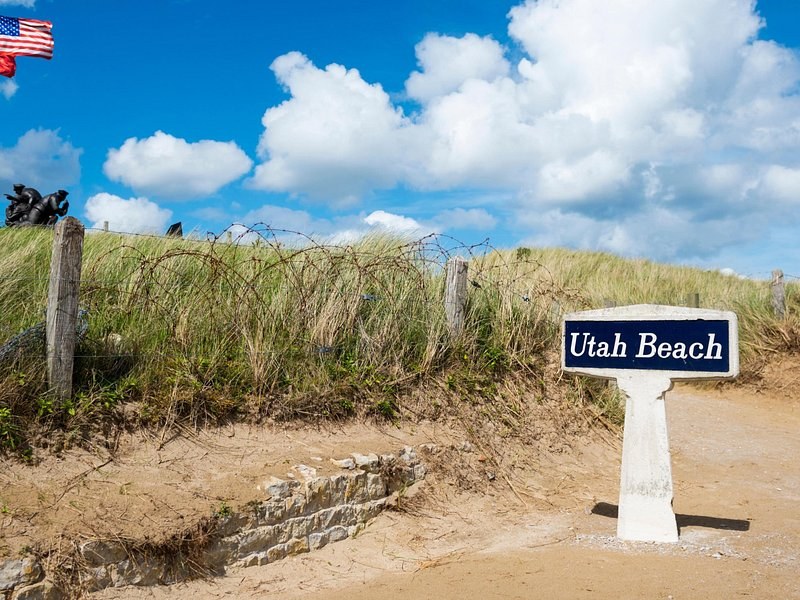 The Utah Beach marker standing in the dune grass